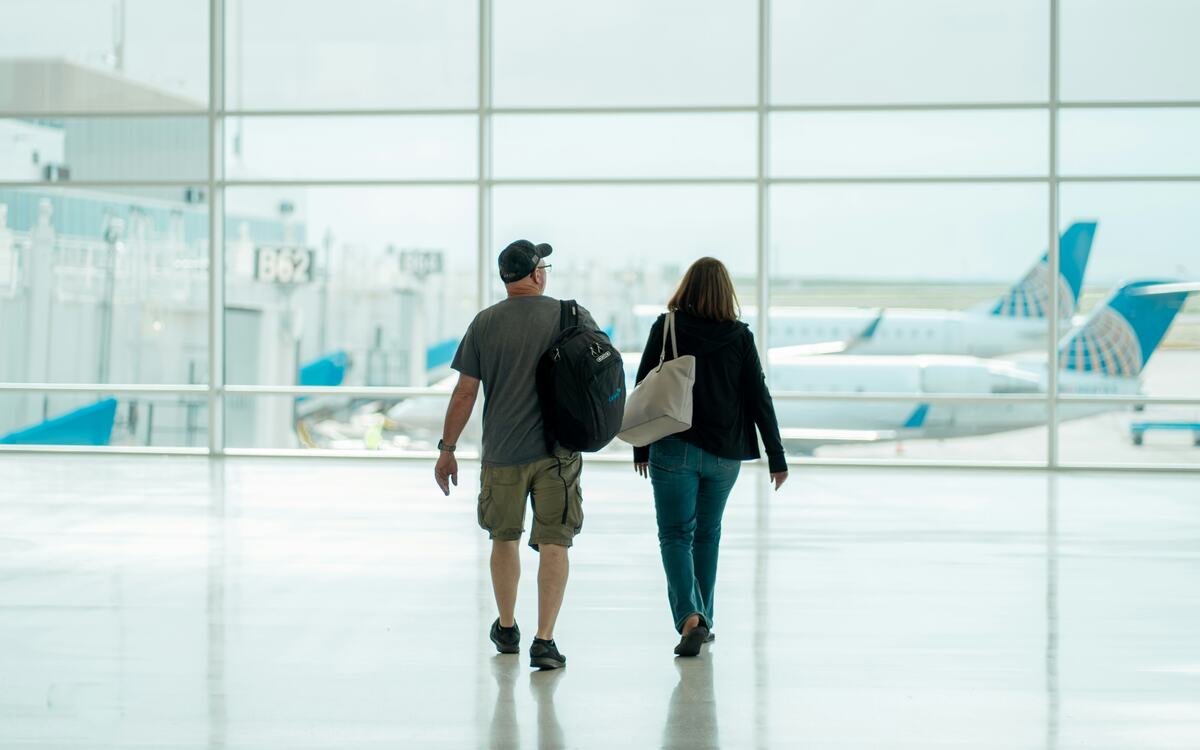 Travellers walking through an airport terminal
