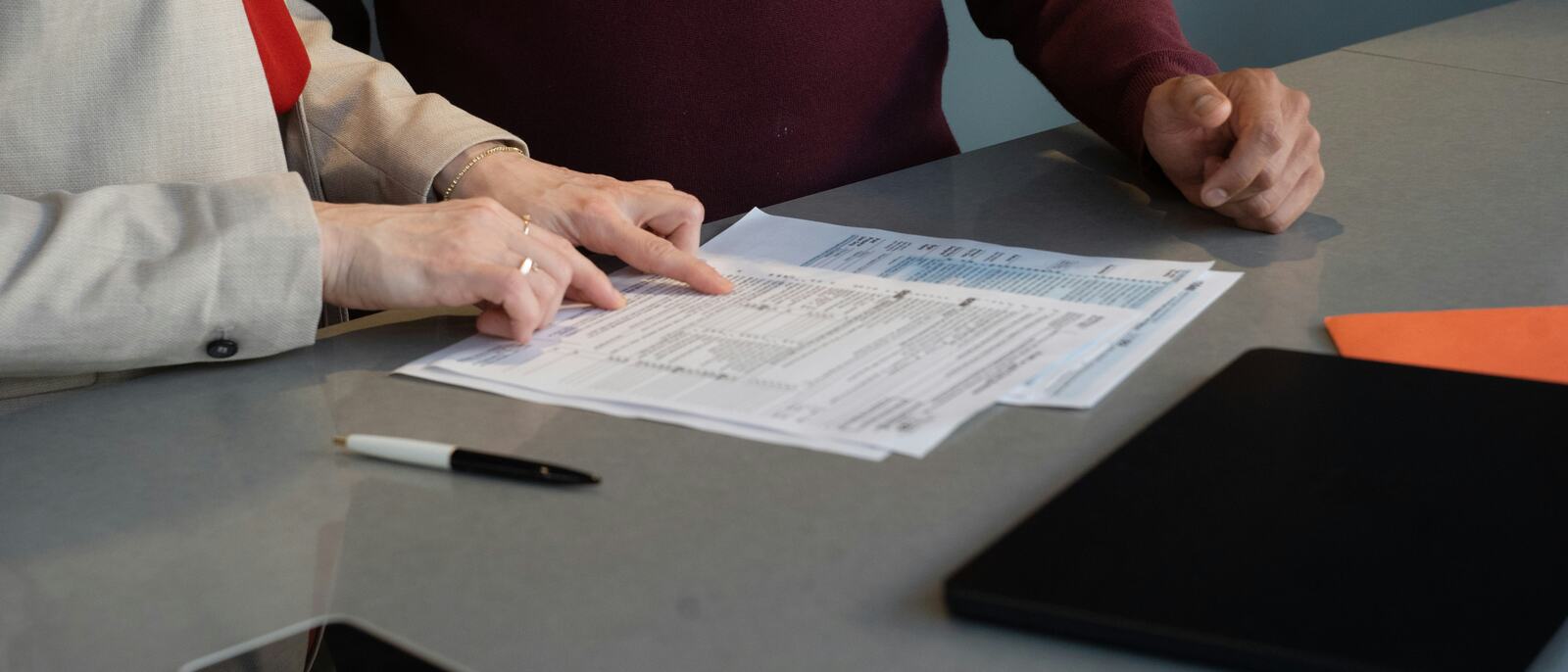 Two people reviewing a form together at a table